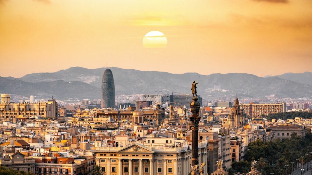 a view of barcelona city with the sunset 